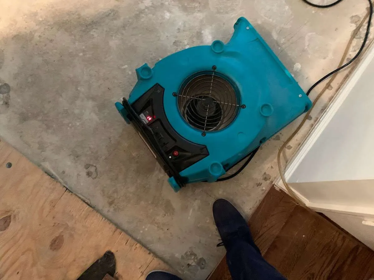 Air mover drying subfloor during Commercial Water Damage Restoration in Lamar